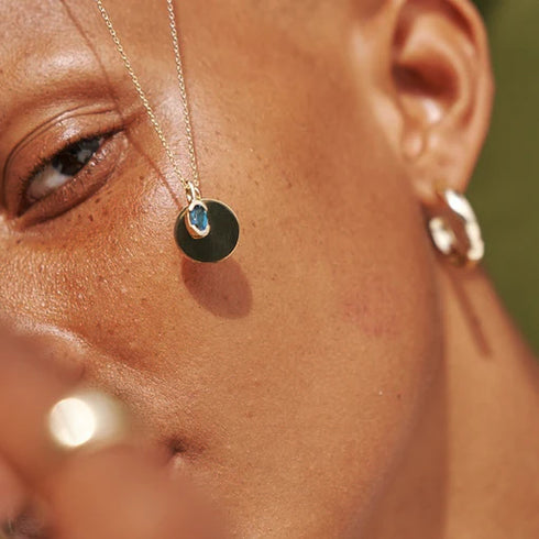 Partial Bezel Set Oval Blue Topaz in Yellow Gold